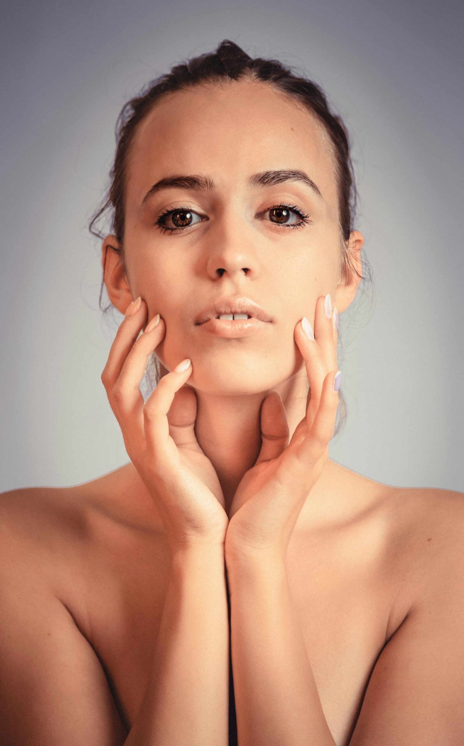 woman holding face bare